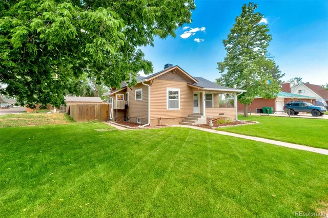 a front view of house with yard and green space