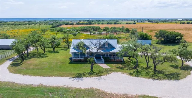 an aerial view of residential houses with outdoor space and river