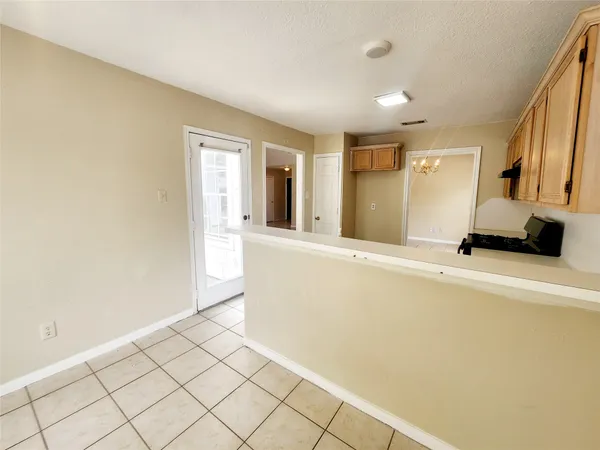 a kitchen with a stove sink and cabinets