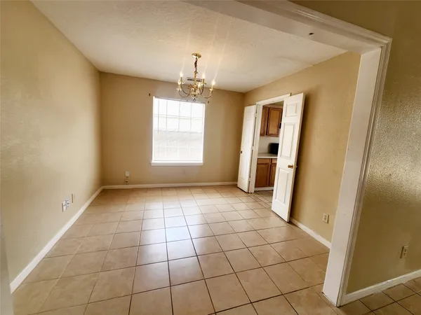 a large white kitchen with a stove a sink dishwasher and a refrigerator