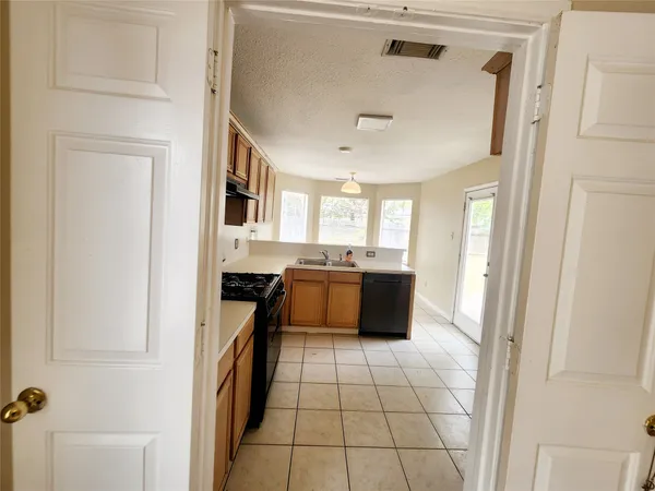 a kitchen with a stove a sink and a microwave
