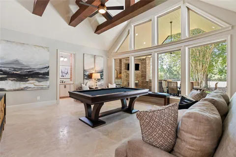 a living room with furniture a rug and a large window