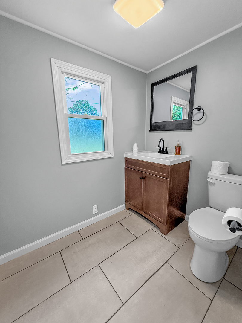 302 West Cook Street Sheffield, IL 61361 - Photo 13 of 18 a bathroom with a toilet sink and mirror