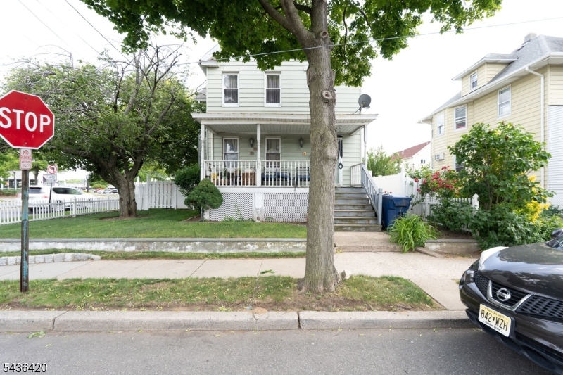 33 Pulaski Place Hackensack, NJ 07601 - Photo 3 of 31 a view of a house with a yard and table and chairs under an umbrella