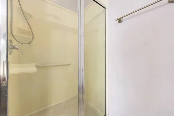 a bathroom with a glass shower door