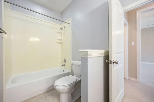 a bathroom with a shower a toilet and a bathtub