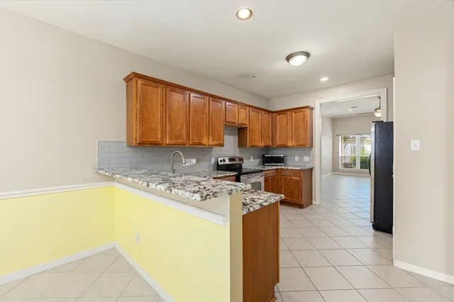 a kitchen with a sink a counter top space cabinets and stainless steel appliances