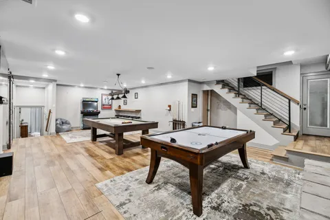 a view of a dining room with furniture a chandelier and wooden floor