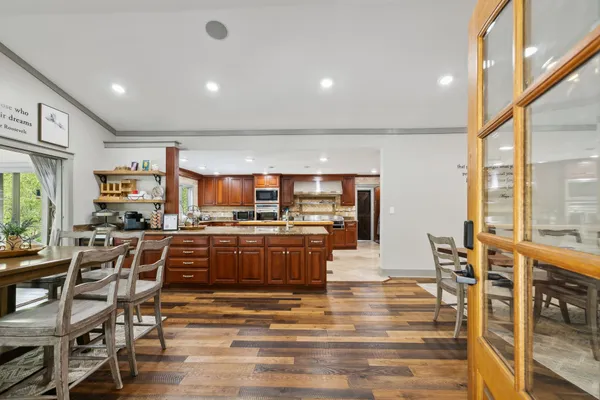 a view of a a dining room with furniture window and wooden floor
