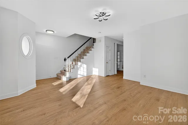 a view of empty room with wooden floor