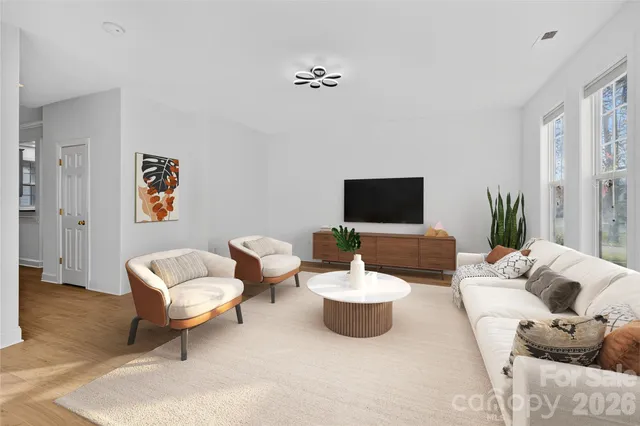 a living room with furniture and a flat screen tv