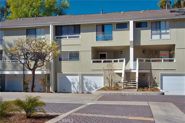 a view of a lake with a bench and trees around