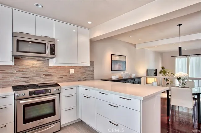 a kitchen with a sink stove and microwave