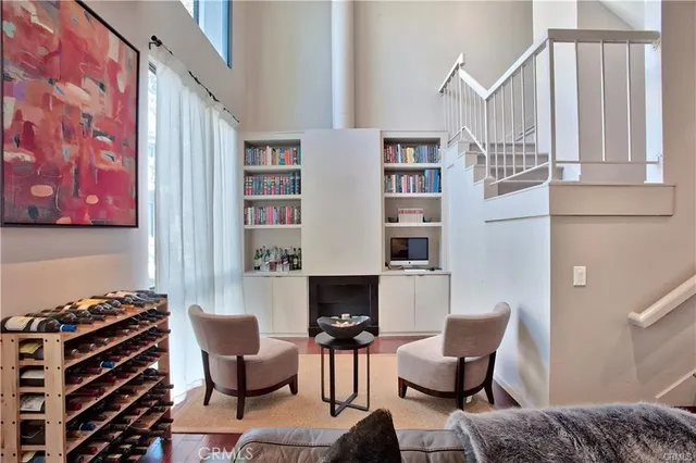 a living room with furniture a fireplace and a book shelf