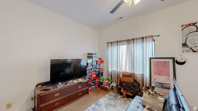 630 1100 West Provo, UT 84601 - Photo 55 of 64 Room featuring light neutral wall paint, a window with striped curtains, and a ceiling fan with integrated lighting