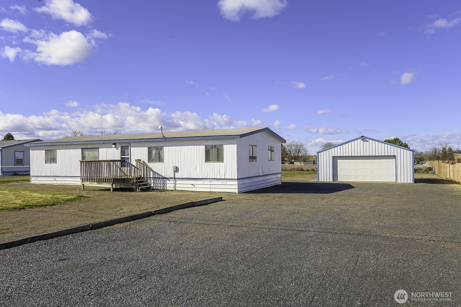 4934 Rd M Northeast Moses Lake, WA 98837 - Photo 1 of 34 a front view of a house with a yard and garage