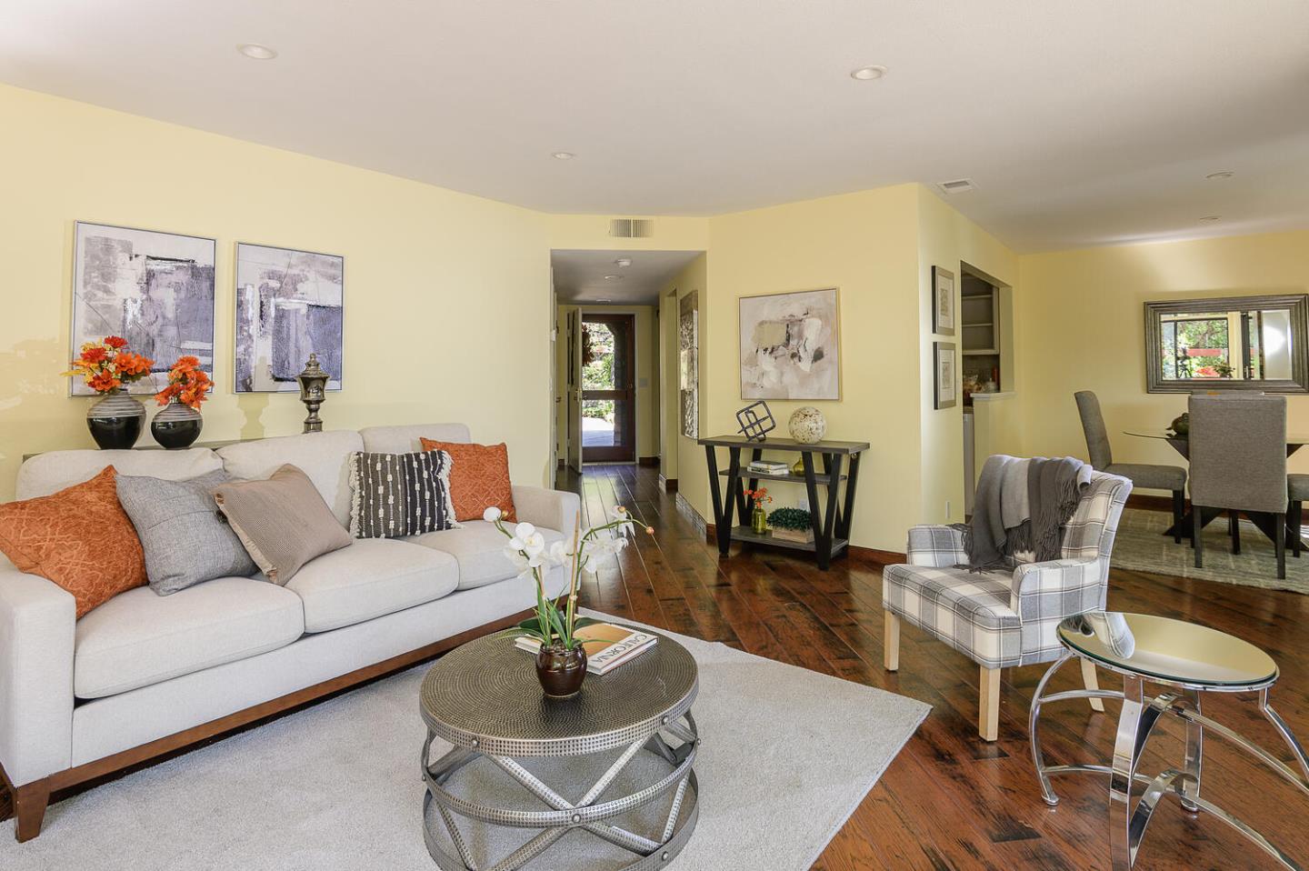 a living room with furniture and wooden floor