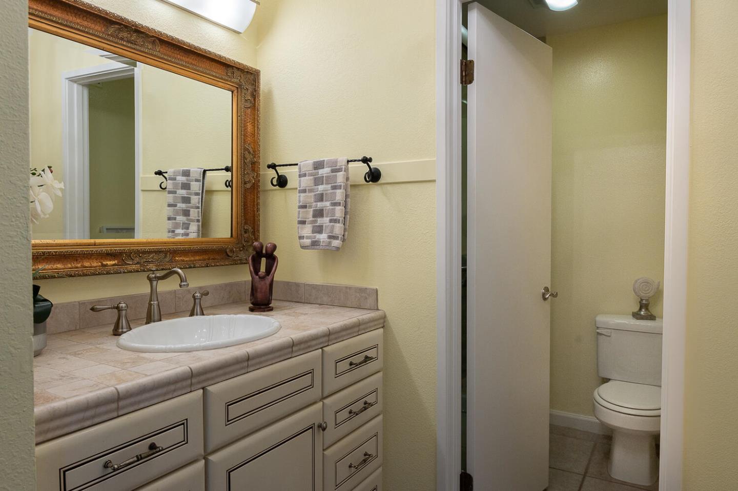 137 Peter Coutts Circle Stanford, CA 94305 - Photo 12 of 28 a bathroom with a granite countertop sink toilet and mirror