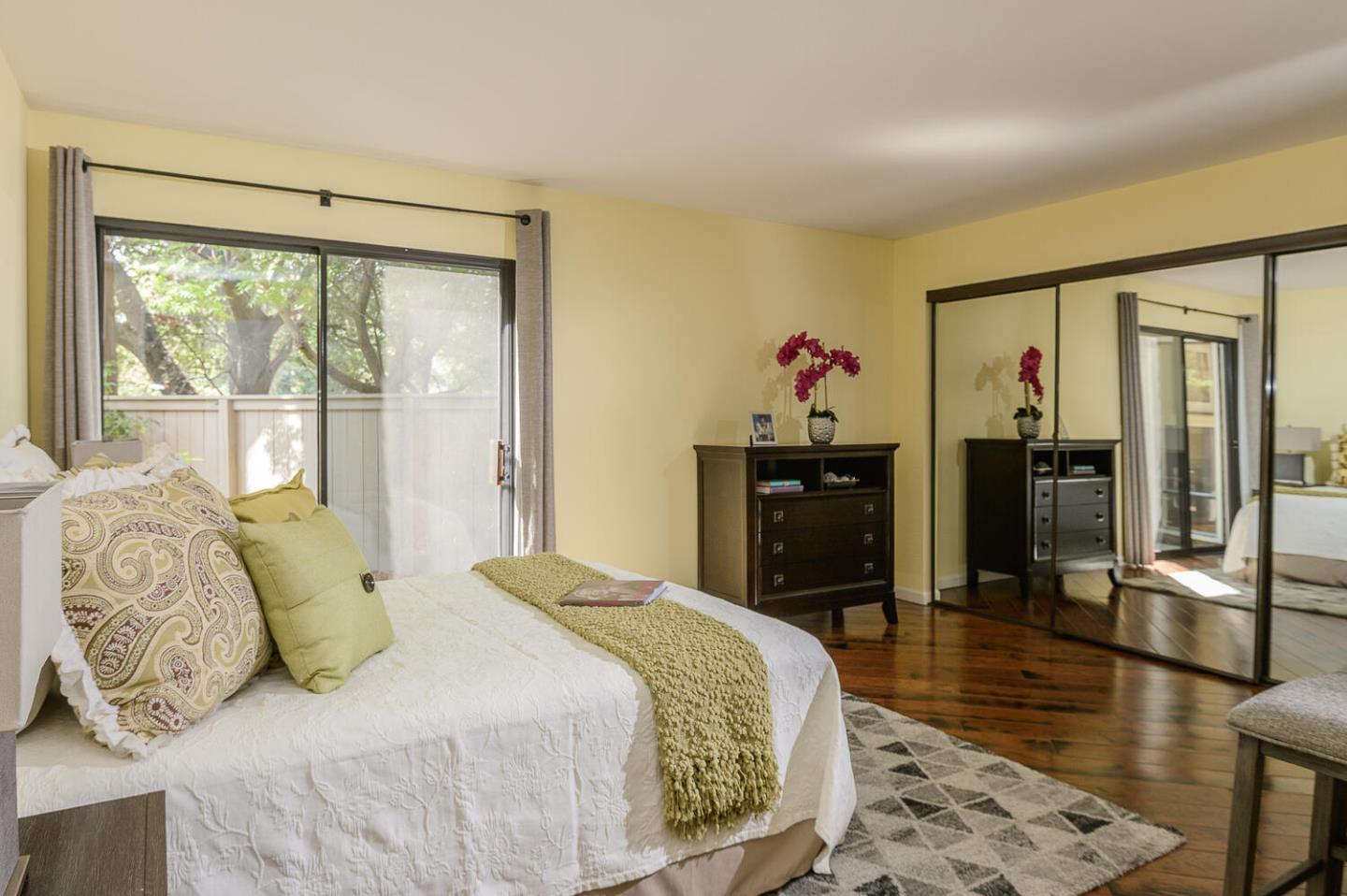 137 Peter Coutts Circle Stanford, CA 94305 - Photo 10 of 28 a bedroom with a balcony a bed and a walk in closet