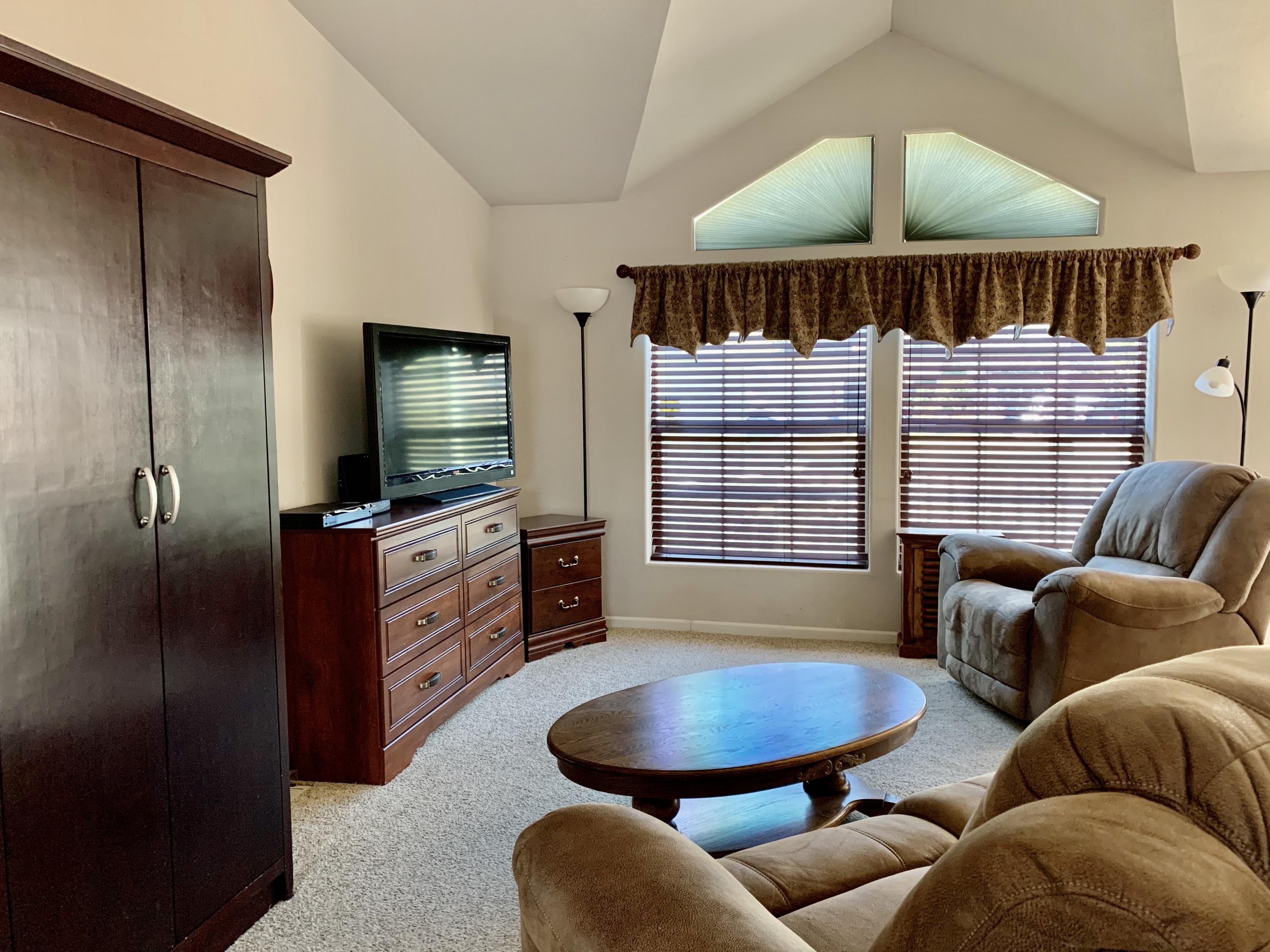 4935 Cedars Road Redding, CA 96001 - Photo 4 of 18 a living room with furniture a window and a flat screen tv