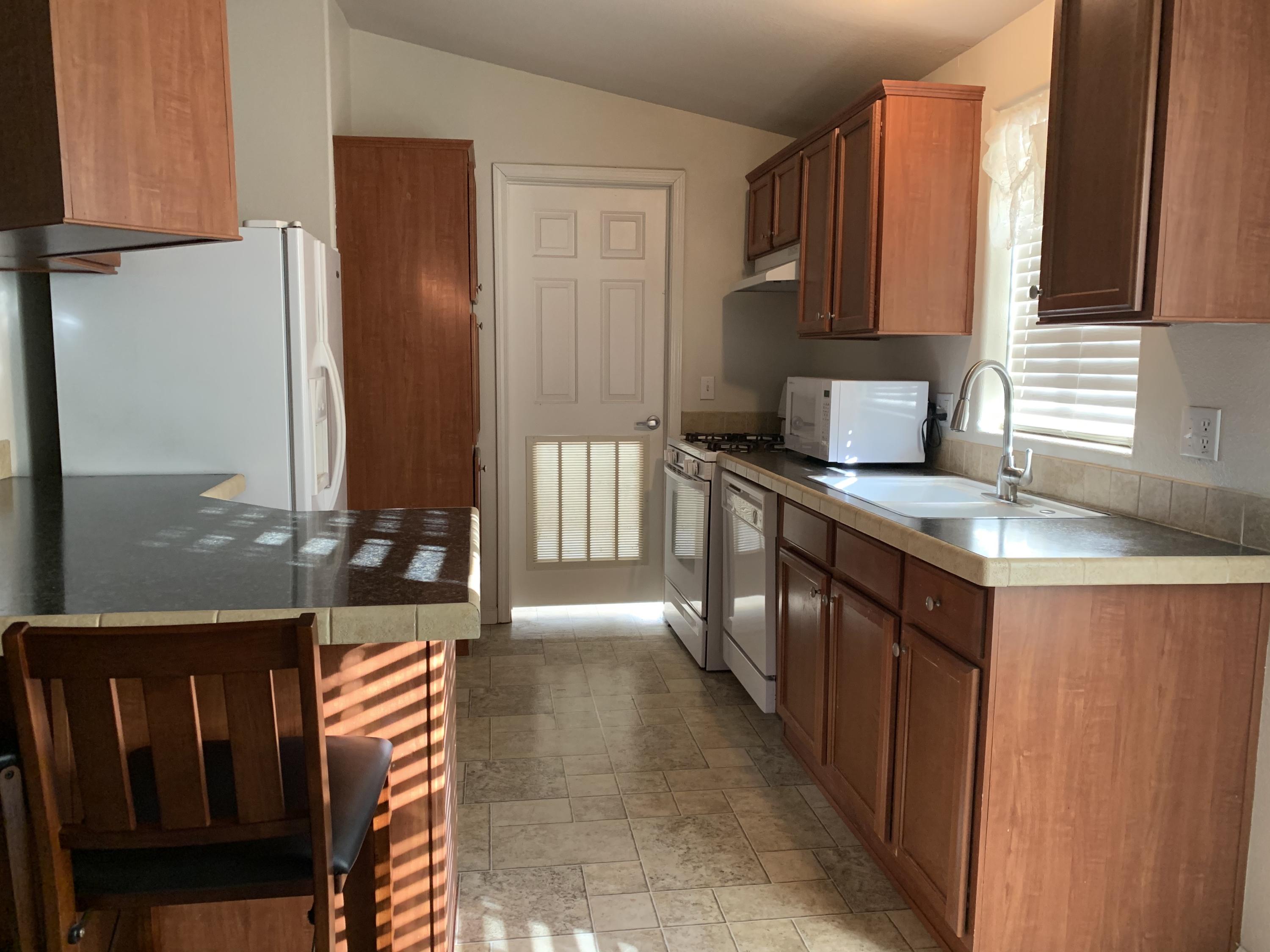 4935 Cedars Road Redding, CA 96001 - Photo 6 of 18 a kitchen with stainless steel appliances granite countertop a sink stove and cabinets