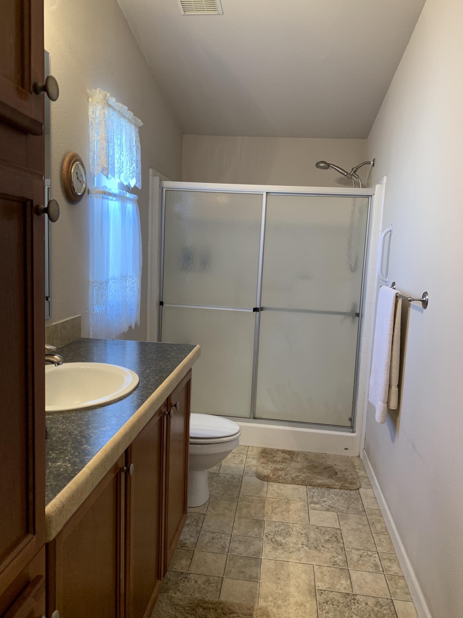 4935 Cedars Road Redding, CA 96001 - Photo 8 of 18 a bathroom with a sink and shower