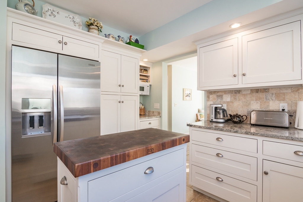 63 Amity Place, Unit 63 Amherst, MA 01002 - Photo 11 of 42 a kitchen with granite countertop a sink stainless steel appliances and cabinets