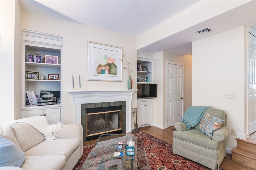 63 Amity Place, Unit 63 Amherst, MA 01002 - Photo 13 of 42 a living room with furniture and a fireplace
