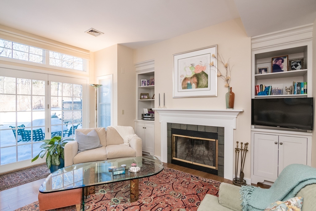 63 Amity Place, Unit 63 Amherst, MA 01002 - Photo 14 of 42 a living room with furniture a flat screen tv and a fireplace