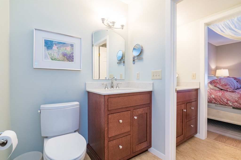 63 Amity Place, Unit 63 Amherst, MA 01002 - Photo 20 of 42 a bathroom with a toilet a sink and mirror