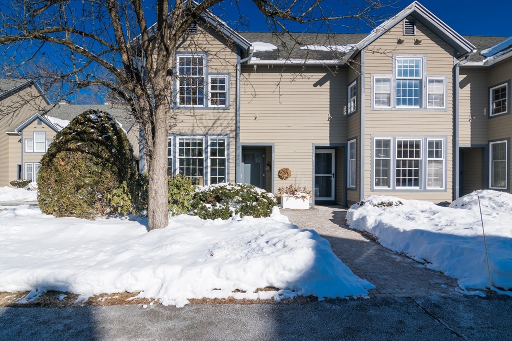 63 Amity Place, Unit 63 Amherst, MA 01002 - Photo 2 of 42 a front view of a house with a yard covered in snow
