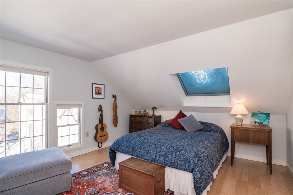 63 Amity Place, Unit 63 Amherst, MA 01002 - Photo 24 of 42 a bedroom with a large bed and wooden floor