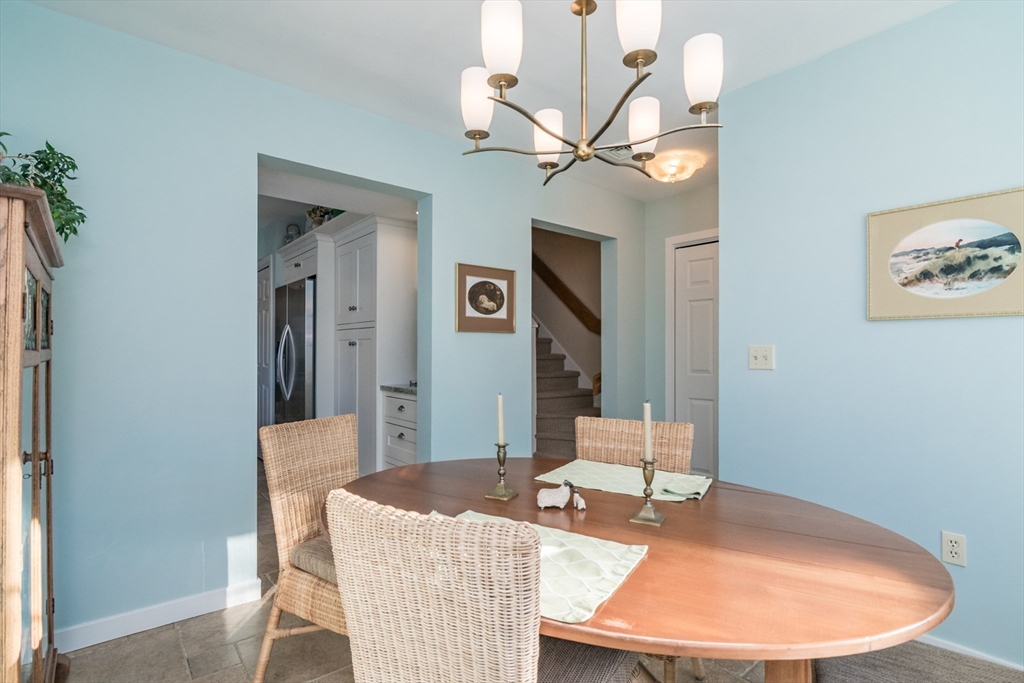 63 Amity Place, Unit 63 Amherst, MA 01002 - Photo 7 of 42 a living room with furniture and a chandelier