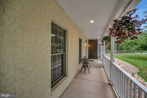 a view of a hallway with wooden floor and windows