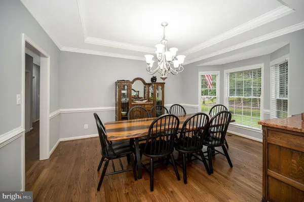 a bathroom with a granite countertop sink and a large mirror
