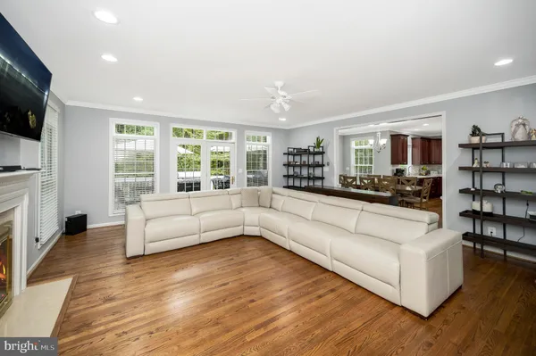 a living room with furniture and a view of kitchen