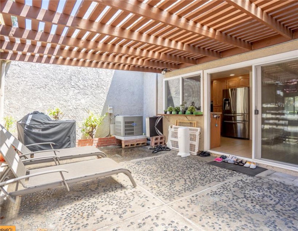 16520 Poppyglen Lane Cerritos, CA 90703 - Photo 14 of 17 a backyard of a house with barbeque oven table and chairs