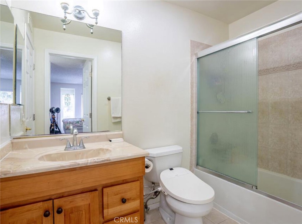 16520 Poppyglen Lane Cerritos, CA 90703 - Photo 4 of 17 a bathroom with a toilet a sink and shower