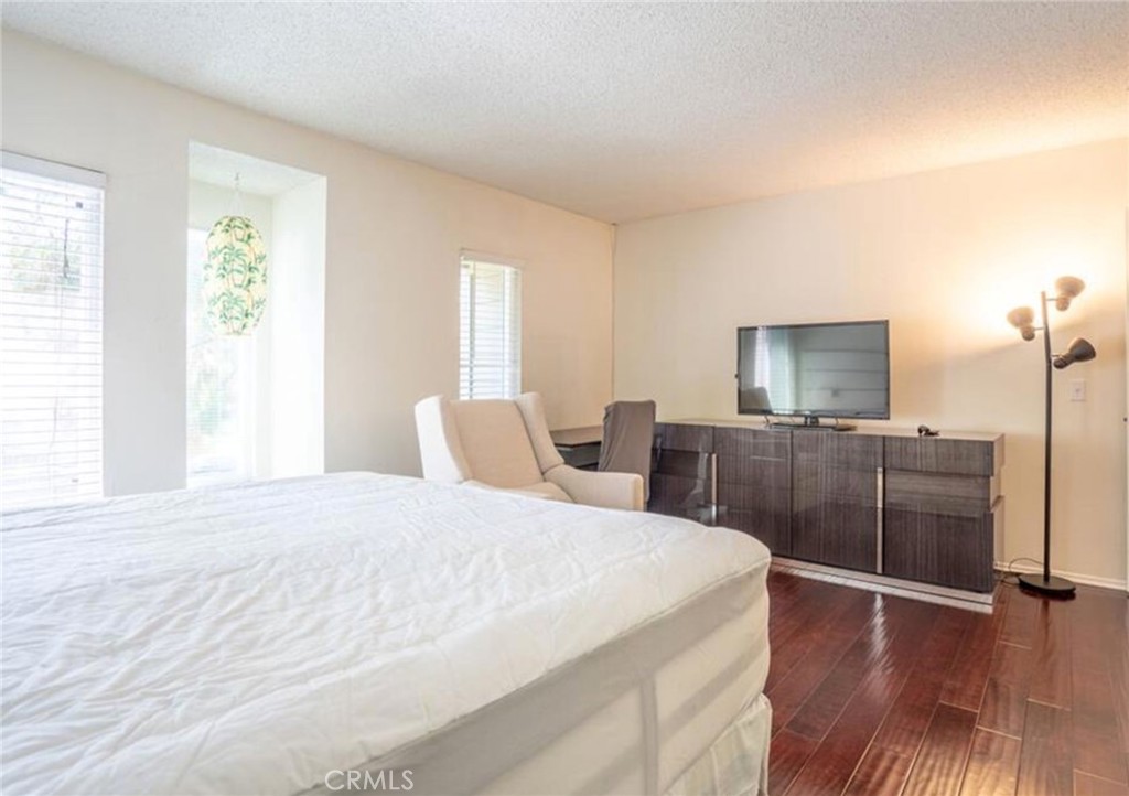 16520 Poppyglen Lane Cerritos, CA 90703 - Photo 7 of 17 a bedroom with a bed and wooden floor