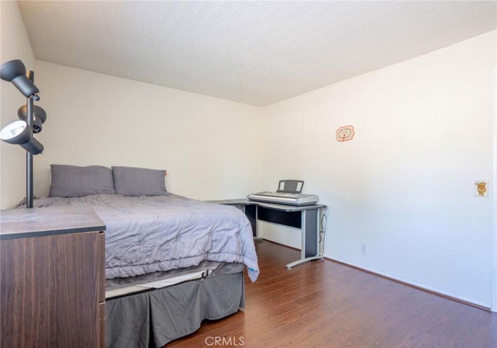 16520 Poppyglen Lane Cerritos, CA 90703 - Photo 8 of 17 a bedroom with a bed and a table