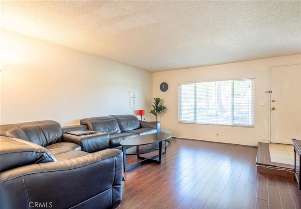 16520 Poppyglen Lane Cerritos, CA 90703 - Photo 9 of 17 a living room with furniture and wooden floor