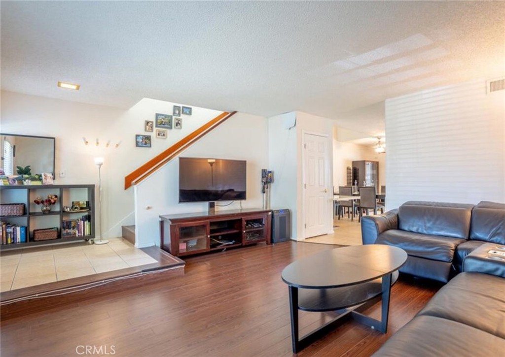 16520 Poppyglen Lane Cerritos, CA 90703 - Photo 10 of 17 a living room with furniture and a flat screen tv