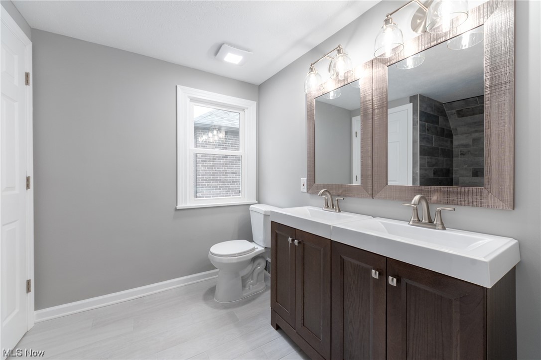2410 Rinard Road Cleveland, OH 44118 - Photo 18 of 24 Bathroom with tile floors, toilet, large vanity, and double sink