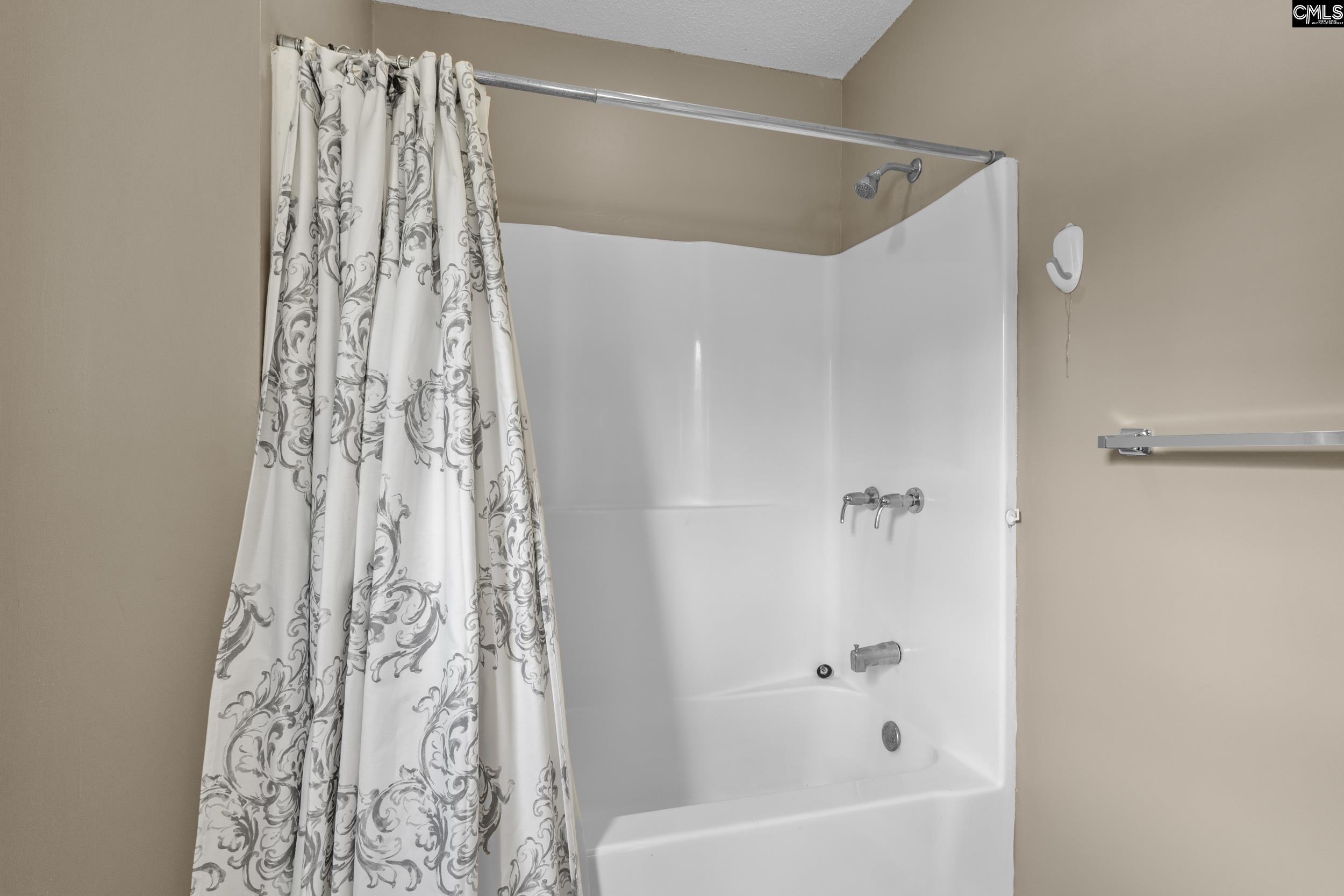 548 Eskie Dixon Road Elgin, SC 29045 - Photo 15 of 27 a bathroom with a bathtub and shower