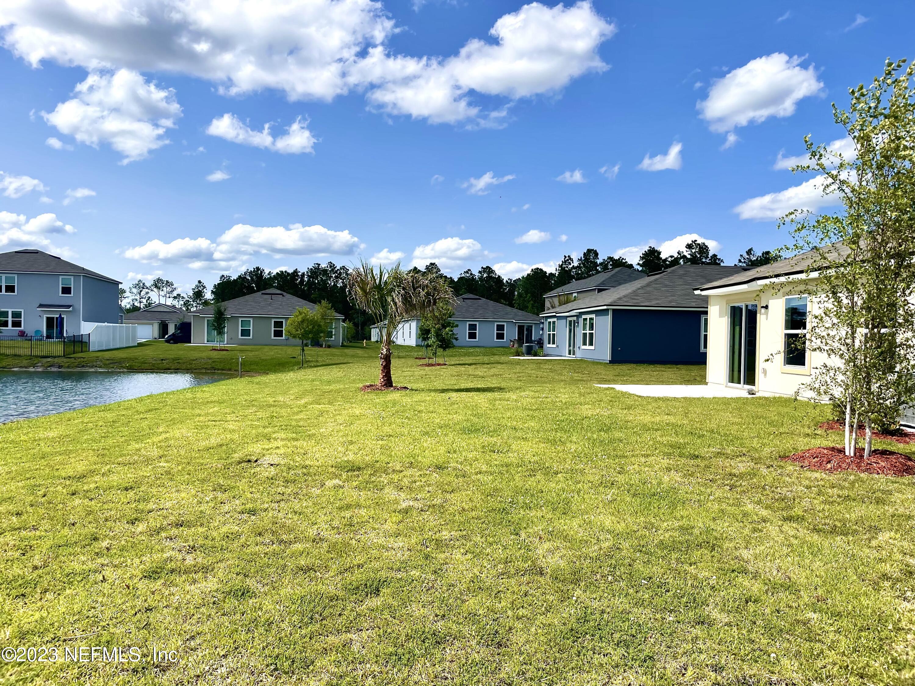 115 Falcon Ridge Road St. Augustine, FL 32084 - Photo 23 of 27 a view of a house with a backyard porch and sitting area