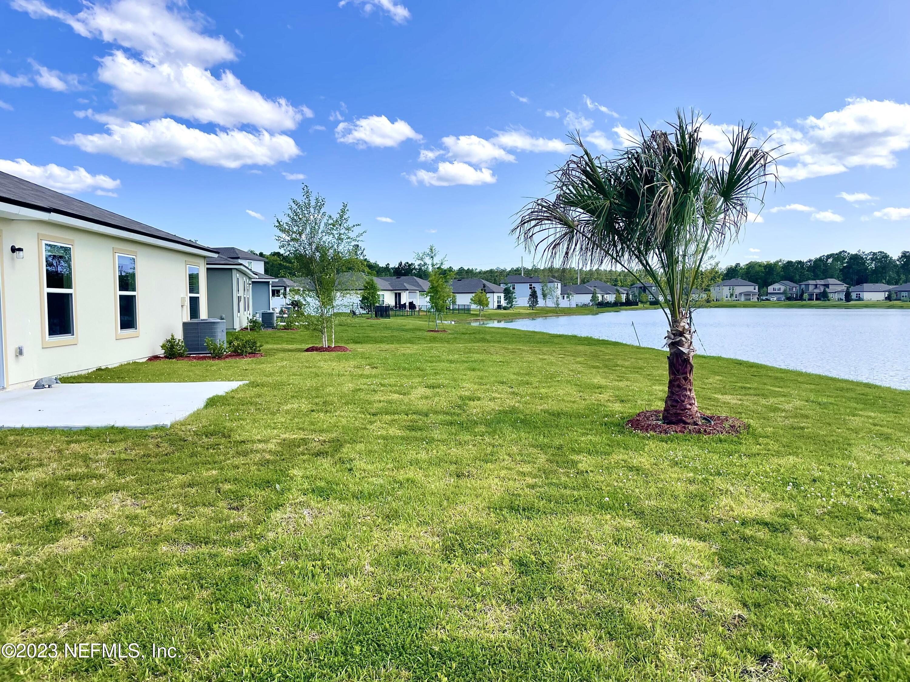 115 Falcon Ridge Road St. Augustine, FL 32084 - Photo 24 of 27 a swimming pool with outdoor seating and yard