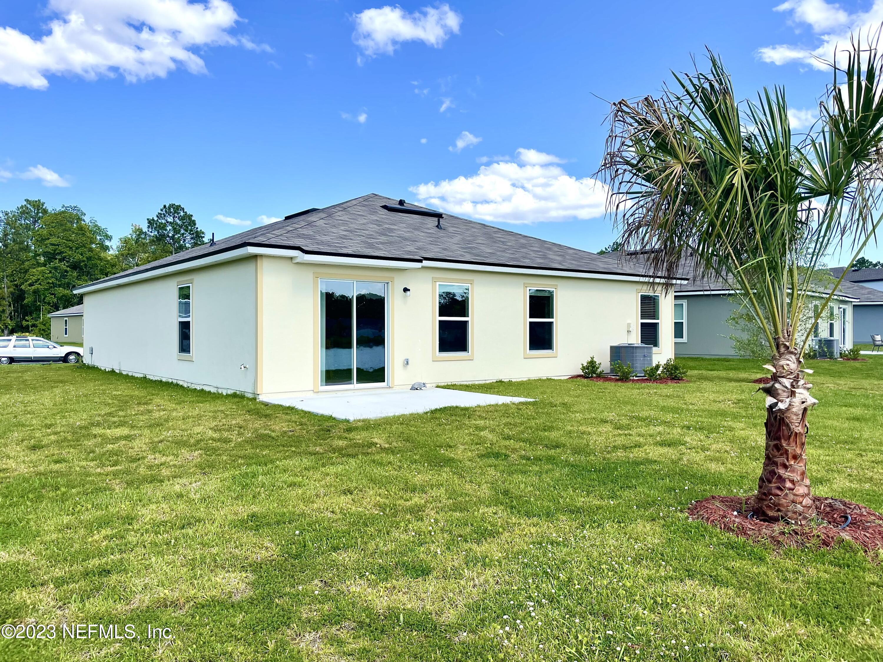 115 Falcon Ridge Road St. Augustine, FL 32084 - Photo 27 of 27 a view of a house with backyard and garden