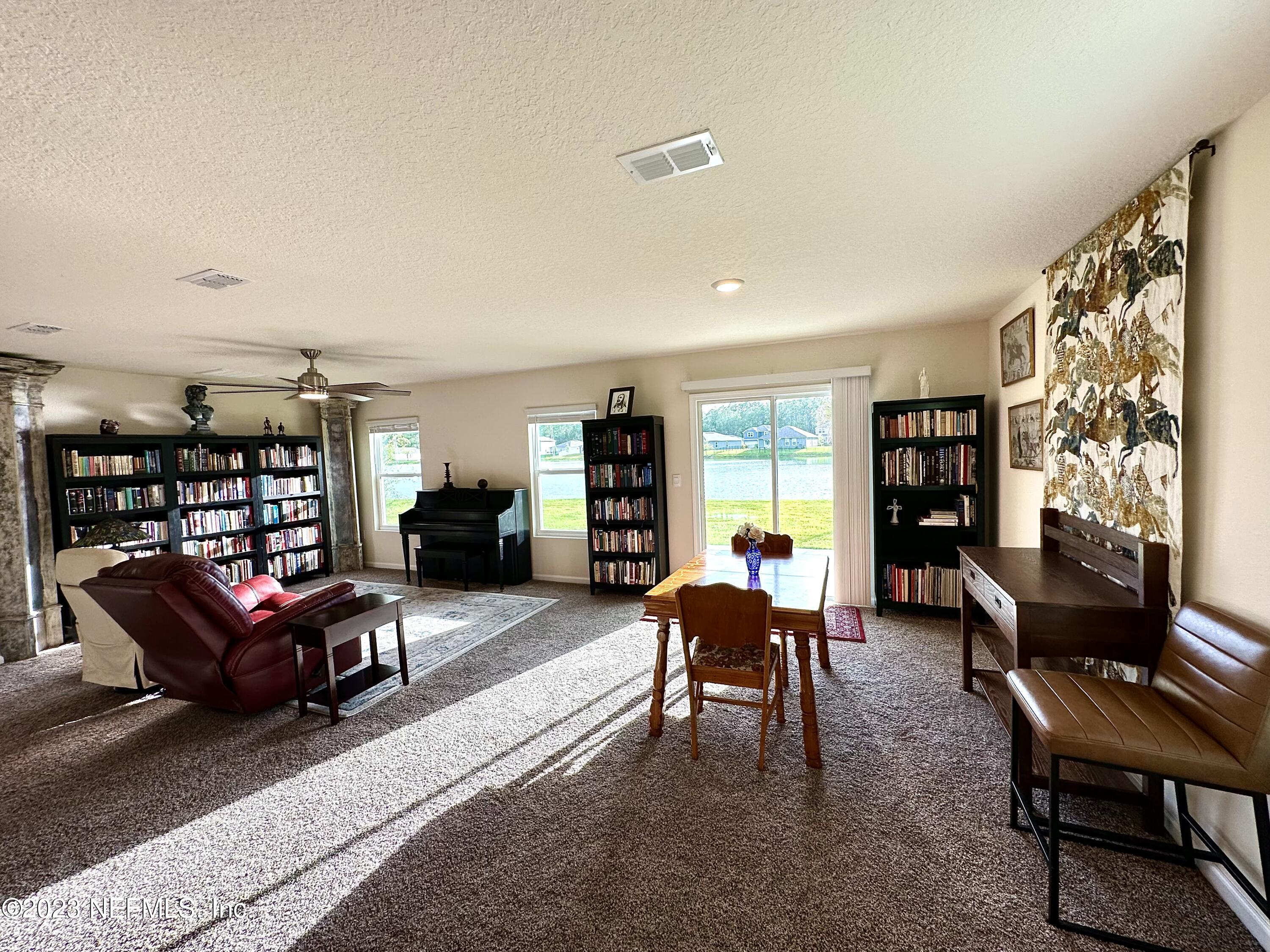 115 Falcon Ridge Road St. Augustine, FL 32084 - Photo 4 of 27 a living room with furniture and a large window