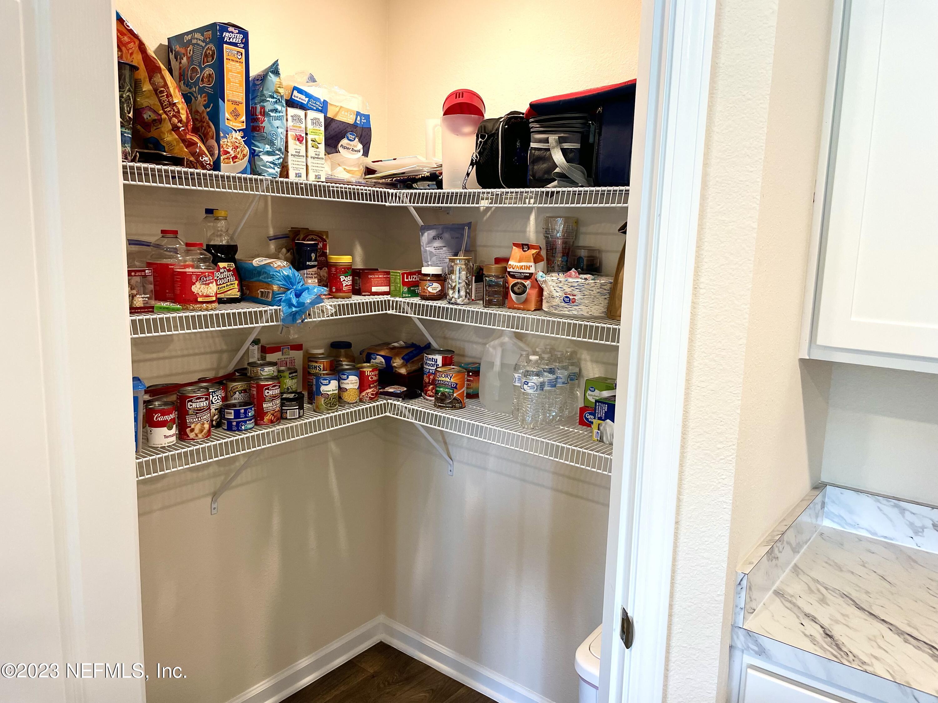 115 Falcon Ridge Road St. Augustine, FL 32084 - Photo 10 of 27 a storage room with washer and lots of different kinds of stuff