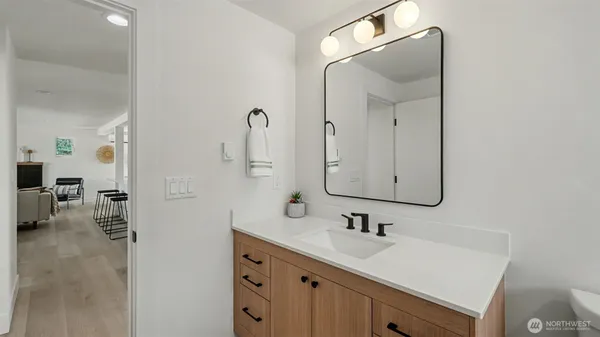 a bathroom with a sink vanity and a mirror
